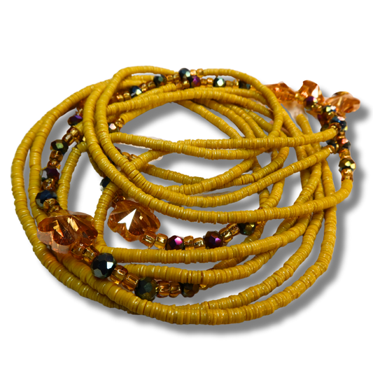 yellow flat disc beads with flower accents and gold and purple crystal accents